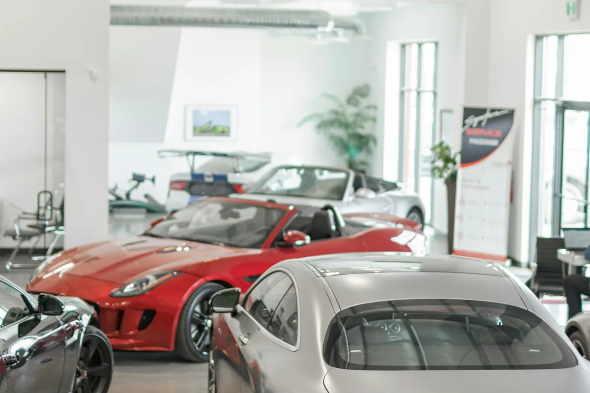 Cars lined up in a dealership showroom