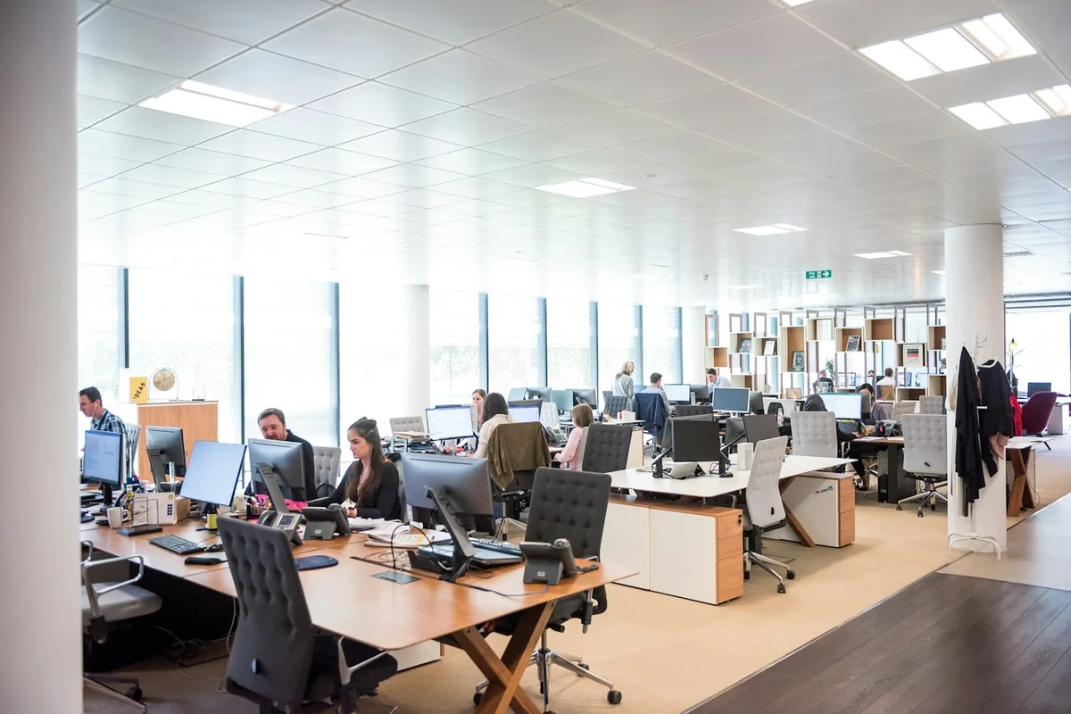 Office staff working at desks in an open plan office